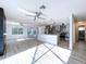 Open-concept living space offers updated kitchen and access to backyard pool views from multiple windows at 8600 Berkley Dr, Hudson, FL 34667