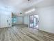 Spacious living room with hardwood floors, a patio door, and modern light fixtures at 8600 Berkley Dr, Hudson, FL 34667