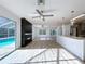 Bright, open living space features an updated kitchen and fireplace with a view of the backyard pool at 8600 Berkley Dr, Hudson, FL 34667