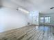 Bright living room featuring modern chandelier and stylish wood-look flooring at 8600 Berkley Dr, Hudson, FL 34667