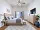 Staged main bedroom featuring hardwood floors and access to a screened-in lanai at 8600 Berkley Dr, Hudson, FL 34667