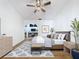Staged main bedroom featuring hardwood floors, a fan, and access to an en-suite bathroom at 8600 Berkley Dr, Hudson, FL 34667