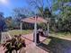 Covered outdoor kitchen features a stainless steel grill and prep area, perfect for backyard entertaining at 8600 Berkley Dr, Hudson, FL 34667