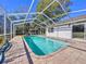Private screened in pool, surrounded by a paved patio at 8600 Berkley Dr, Hudson, FL 34667