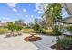 Backyard patio with outdoor dining furniture and landscaped yard at 11124 Corlett Rd, Riverview, FL 33578