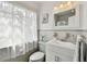 Bright bathroom featuring a vanity sink, decoratives, and a large window at 11124 Corlett Rd, Riverview, FL 33578