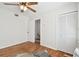Bright bedroom features hardwood floors, ceiling fan, and closet with bi-fold doors at 11124 Corlett Rd, Riverview, FL 33578
