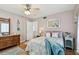 Bedroom featuring hardwood floors, patterned bedding, bright natural light, and ample storage space at 11124 Corlett Rd, Riverview, FL 33578