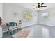 Bedroom with gray floors, furniture, ceiling fan and bright windows at 11124 Corlett Rd, Riverview, FL 33578