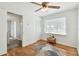 Spare bedroom features hardwood floors, neutral wall color, a ceiling fan, and a bright window at 11124 Corlett Rd, Riverview, FL 33578