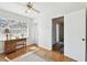Bedroom with hardwood floors, desk by bright windows and a ceiling fan at 11124 Corlett Rd, Riverview, FL 33578