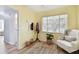 Sunny bedroom features a comfortable chair and neutral rug at 11124 Corlett Rd, Riverview, FL 33578