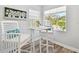 Bright breakfast nook features a window brick design and contemporary white table and chairs at 11124 Corlett Rd, Riverview, FL 33578