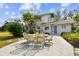 Exterior view of the home with an outdoor dining set at 11124 Corlett Rd, Riverview, FL 33578