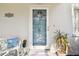 Close-up of the front door, featuring a decorative welcome sign and a charming seating area at 11124 Corlett Rd, Riverview, FL 33578