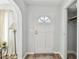 Hallway view of interior door with a sunburst window and convenient access to storage at 11124 Corlett Rd, Riverview, FL 33578