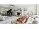 Bright living room featuring a piano, fireplace, and comfortable seating arrangement at 11124 Corlett Rd, Riverview, FL 33578