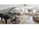 Spacious living room with hardwood floors, piano, and decorative fireplace at 11124 Corlett Rd, Riverview, FL 33578