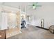 Spacious main bedroom with accessible shower, ceiling fan, white walls, and neutral carpet flooring at 11124 Corlett Rd, Riverview, FL 33578