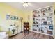 Bright office featuring built-in shelves, decorative displays, and comfortable seating at 11124 Corlett Rd, Riverview, FL 33578