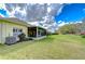 Lush backyard with screened lanai, showcasing the property's outdoor living space and peaceful setting at 1168 Emerald Hill Way, Valrico, FL 33594