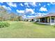 Expansive backyard featuring lush lawn and screened lanai, perfect for outdoor living and entertaining at 1168 Emerald Hill Way, Valrico, FL 33594