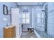 Well-lit bathroom featuring a glass-enclosed shower and a storage cabinet at 1168 Emerald Hill Way, Valrico, FL 33594