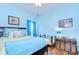 Light blue bedroom featuring a queen size bed and a vintage steamer trunk at 1168 Emerald Hill Way, Valrico, FL 33594