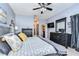 Spacious bedroom with a ceiling fan, a large dresser, and neutral-colored walls at 1168 Emerald Hill Way, Valrico, FL 33594