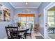 Cozy dining area with round table, decorative window treatment, and neutral paint at 1168 Emerald Hill Way, Valrico, FL 33594