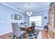 Elegant dining room featuring a modern chandelier, decorative rug, and stylish furnishings at 1168 Emerald Hill Way, Valrico, FL 33594