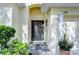 Close up on a front entrance featuring a decorative door with sidelights and a stylish wreath at 1168 Emerald Hill Way, Valrico, FL 33594