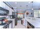 Bright kitchen featuring white cabinets, black appliances, and tile backsplash at 1168 Emerald Hill Way, Valrico, FL 33594