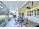 Enclosed patio featuring a table with seating and a ceiling fan at 1168 Emerald Hill Way, Valrico, FL 33594