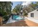 Backyard pool with fence, adjacent to the deck and house at 1209 E Idlewild Ave, Tampa, FL 33604