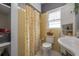 Classic bathroom features yellow tiles, white fixtures and a shower curtain at 1209 E Idlewild Ave, Tampa, FL 33604