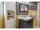 A bathroom features yellow tile walls, dark vanity, a window and storage cabinet at 1209 E Idlewild Ave, Tampa, FL 33604