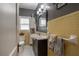 Cozy bathroom featuring yellow tile, black vanity and grey walls at 1209 E Idlewild Ave, Tampa, FL 33604