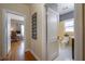 Hallway view to bathroom and bedroom with white doors and hardwood floors at 1209 E Idlewild Ave, Tampa, FL 33604