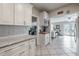 Bright kitchen with white cabinets and subway tile backsplash, flowing into the open living space at 1209 E Idlewild Ave, Tampa, FL 33604