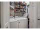 Laundry room with white washer and dryer, wire shelving and storage at 1209 E Idlewild Ave, Tampa, FL 33604