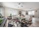 Living room with tile floors, modern sofas, area rug, and double doors at 1209 E Idlewild Ave, Tampa, FL 33604