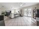 Bright living room with tile flooring, ceiling fans, and double doors to the outside at 1209 E Idlewild Ave, Tampa, FL 33604