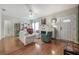 Inviting living room with a fireplace, hardwood floors, neutral decor, and a ceiling fan at 1209 E Idlewild Ave, Tampa, FL 33604