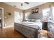 Main bedroom showcasing a large bed, hardwood floors, and views from the bedroom windows at 1209 E Idlewild Ave, Tampa, FL 33604