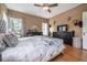 Comfortable main bedroom featuring neutral walls, wood floors and a ceiling fan at 1209 E Idlewild Ave, Tampa, FL 33604