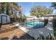 Pool area with shed and mature landscaping at 1209 E Idlewild Ave, Tampa, FL 33604