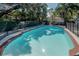 Inground pool with fence, surrounded by mature landscaping at 1209 E Idlewild Ave, Tampa, FL 33604