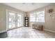 Bright sunroom with tiled floor, storage, and French doors leading to the pool area at 1209 E Idlewild Ave, Tampa, FL 33604