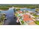 Aerial view of a waterfront house with a private pool, dock, and boat, surrounded by lush greenery at 1324 51St Ne Ave, St Petersburg, FL 33703